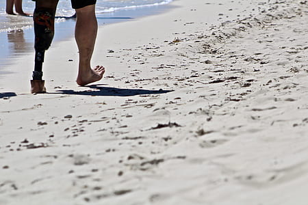 person walking through beach shore thumbnail