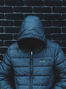 man leaning on black concrete brick thumbnail