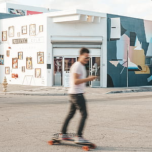 man longboarding in the street thumbnail