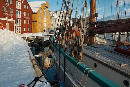 white and teal boat on body of water thumbnail