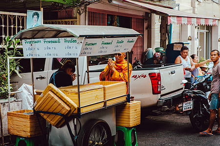 person riding food stall near vehicle thumbnail