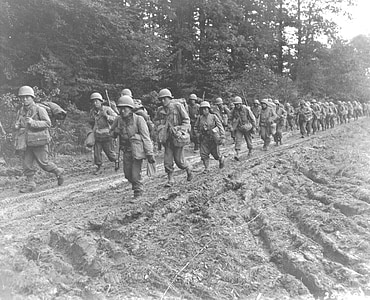 grayscale photo of soldiers walking on road thumbnail