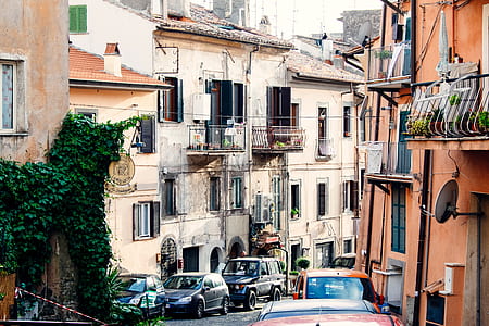 vehicles near concrete building during daytime thumbnail
