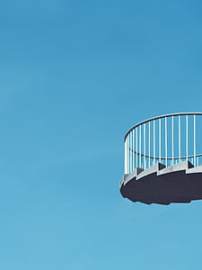 spiral staircase under blue clear sky during daytime thumbnail