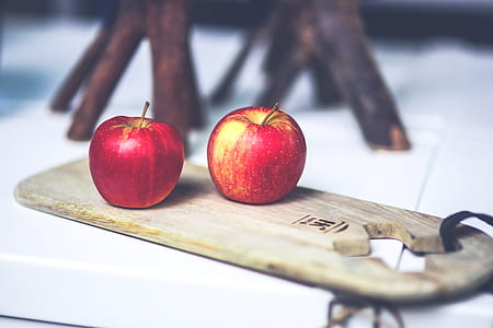 two red apples on brown board thumbnail