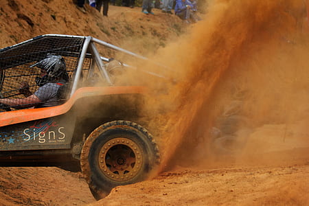 person riding on orange and black go-kart thumbnail