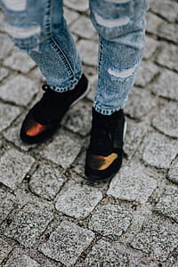 Woman in black sneakers and blue jeans thumbnail