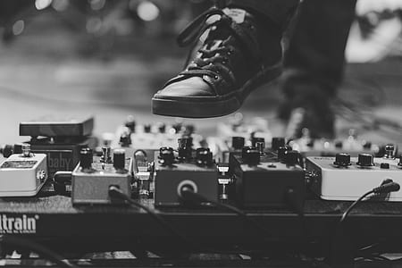 grayscale photography of person wearing low-top shoe thumbnail
