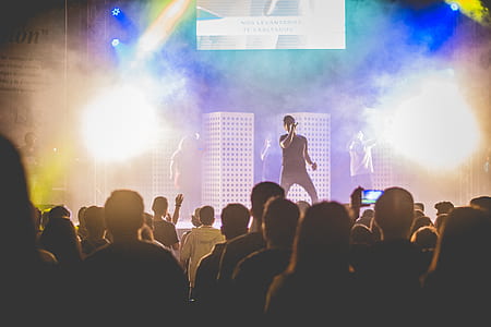 man singing on stage in front of crowd thumbnail