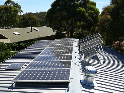 stainless steel roof turbine near solar panels during daytime thumbnail