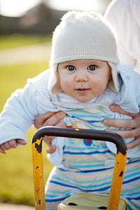 shallow focus photography of person carrying baby thumbnail