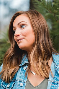 close up photography of woman in blue-washed denim jacket thumbnail