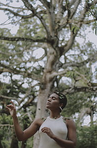 Woman Closing Her Eyes With Leaves on Her Shoulder thumbnail