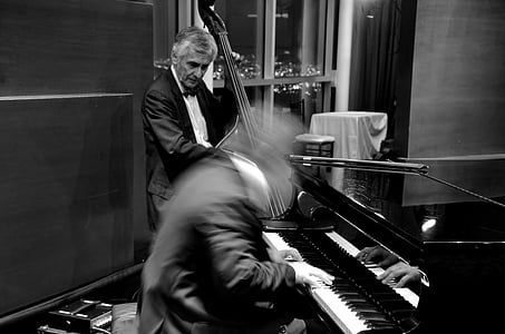 grayscale photo of performing with musical instruments thumbnail