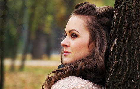 woman in white top laying her back on tree thumbnail