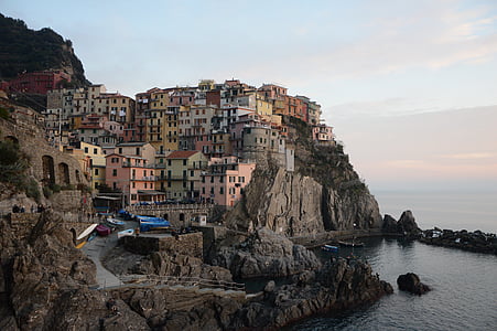 assorted-color buildings on cliff at daytime thumbnail