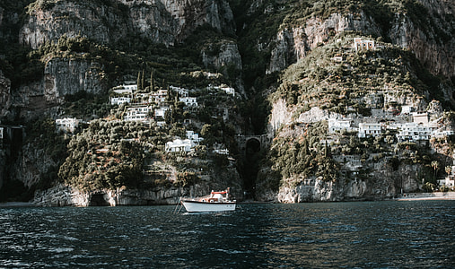 landscape photography of boat and houses thumbnail