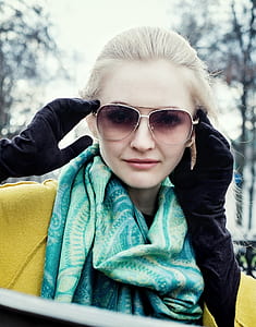 woman wearing purple sunglasses and pair of blue gloves thumbnail