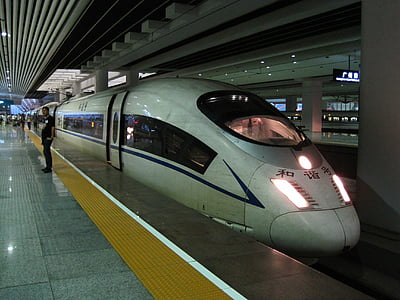 person standing near a bullet train thumbnail