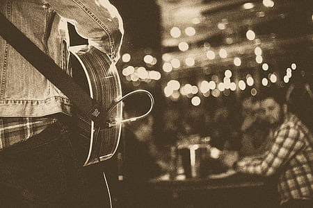 grayscale photo of person playing guitar thumbnail