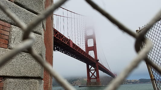 Golden Bridge under white cloudy sky thumbnail