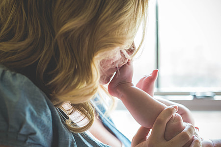 woman kissing baby's foot thumbnail