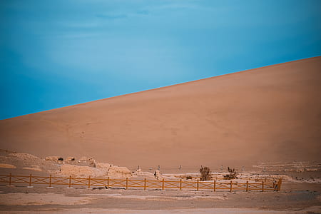 landscape photography of brown wooden fences in the middle of desert during daytime thumbnail