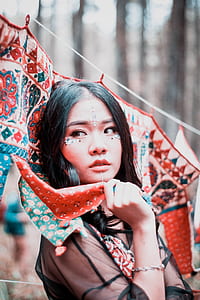woman holding textile during daytime thumbnail