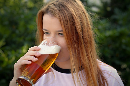 woman drinking glass of beer thumbnail