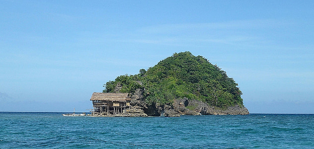 islet with green trees during daytime thumbnail