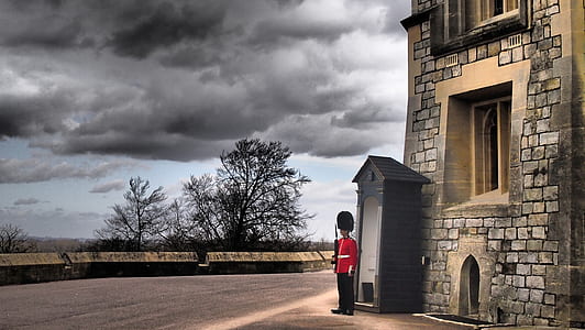man standing near brick building thumbnail