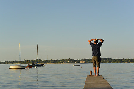 man standing on boat dock thumbnail