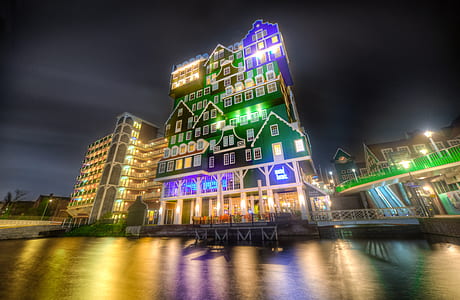 low-angle photo of green and purple lighted building during nighttime thumbnail
