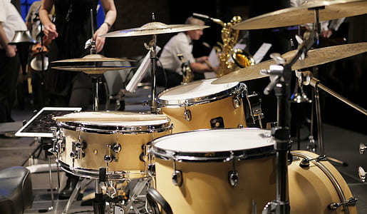 brass-colored and white drum kit close-up photo thumbnail