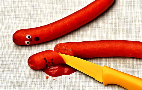 orange knife beside hotdog thumbnail