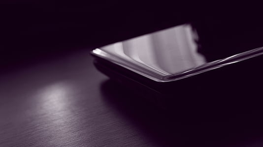 black smartphone turned-off on table thumbnail