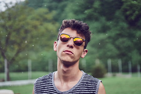 shallow focus of man standing outdoors during daytime thumbnail