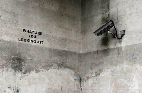 black surveillance camera looking at What Are You Looking At? graffiti thumbnail