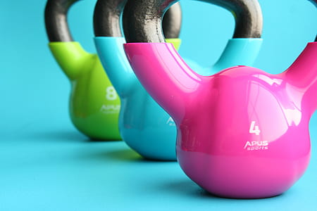 three pink , blue, and green kettle bells thumbnail