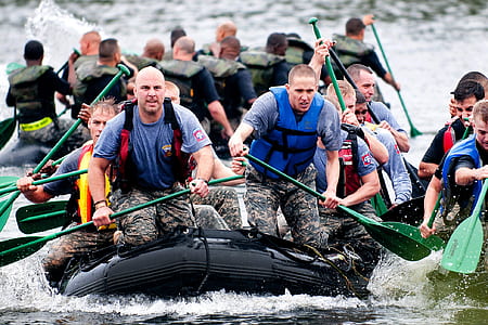 Men Paddling in Inflatable Raft Boat during Daytime thumbnail