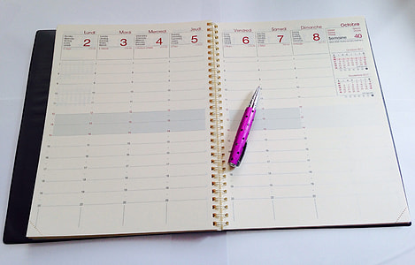 pink click pen on white notebook thumbnail