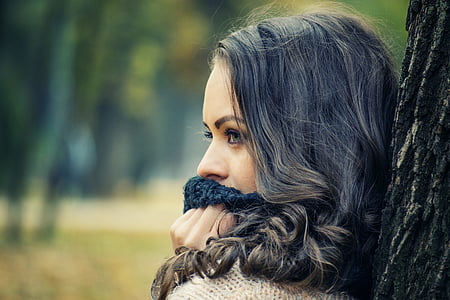 gray haired woman behind tree thumbnail