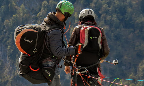 two person wearing assorted-color backpacks thumbnail