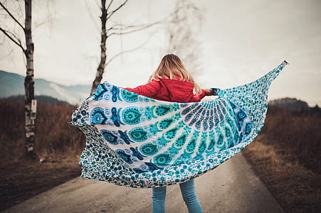 Woman Standing on the Middle of the Road Holding Blanket thumbnail