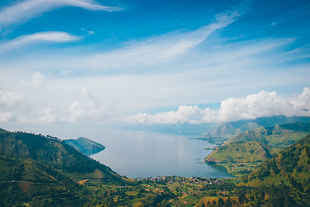 green mountains near body of water at daytime thumbnail