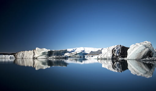 landscape photo of body of water with rock formation thumbnail