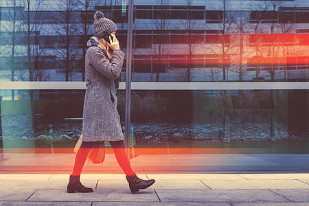 Trendy business woman goes and calling with her smartphone at the office center thumbnail