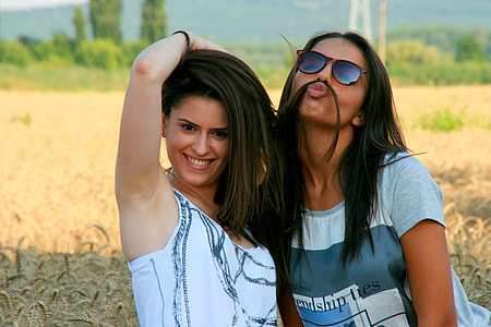 two woman standing outdoors thumbnail