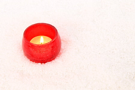 beige tealight lighted candle on white textil thumbnail