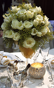 white flower on clear glass flower vase on white wooden table thumbnail
